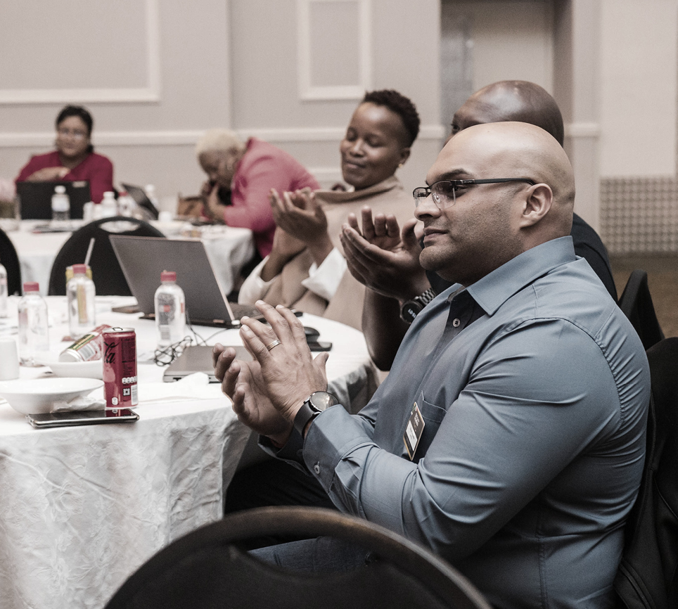 Delegates applauding at a Topco conference